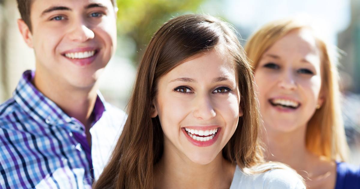 Teens wearing Invisalign aligners in Asheville