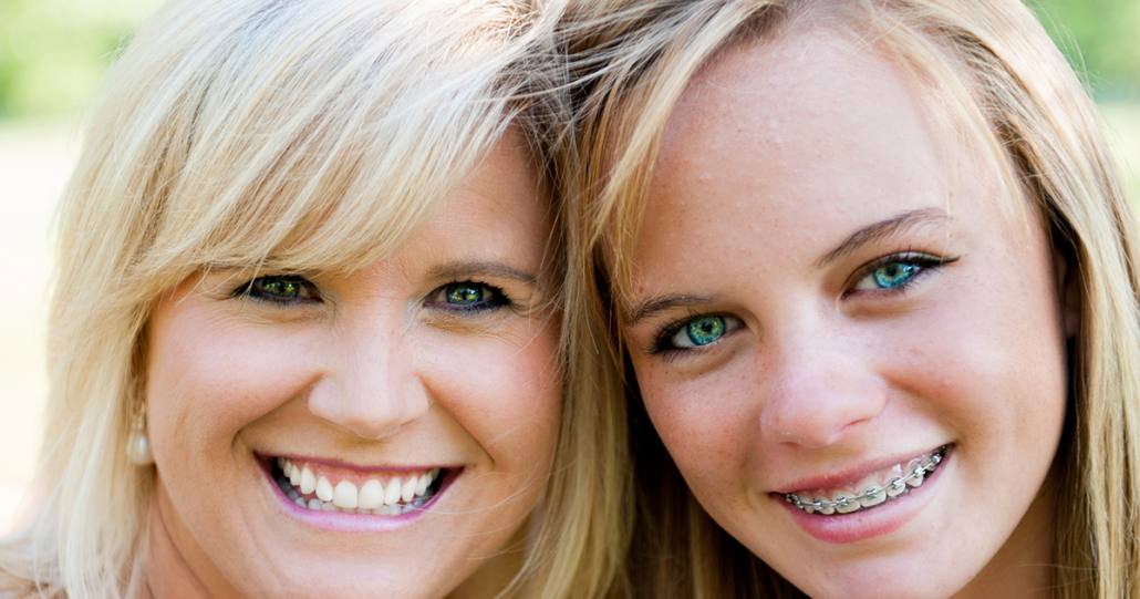 Teen with ceramic braces smiling for picture in Asheville