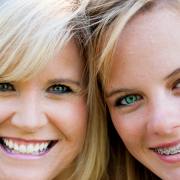 Advantages of Ceramic Braces Teen with ceramic braces smiling for picture in Asheville