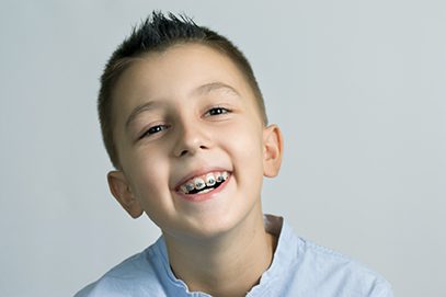 Boy with braces smiling in Asheville, NC