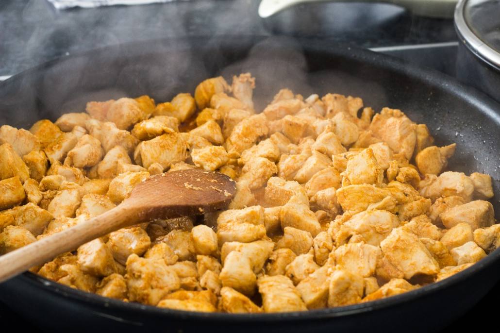 Adult with braces prepares chicken for dinner