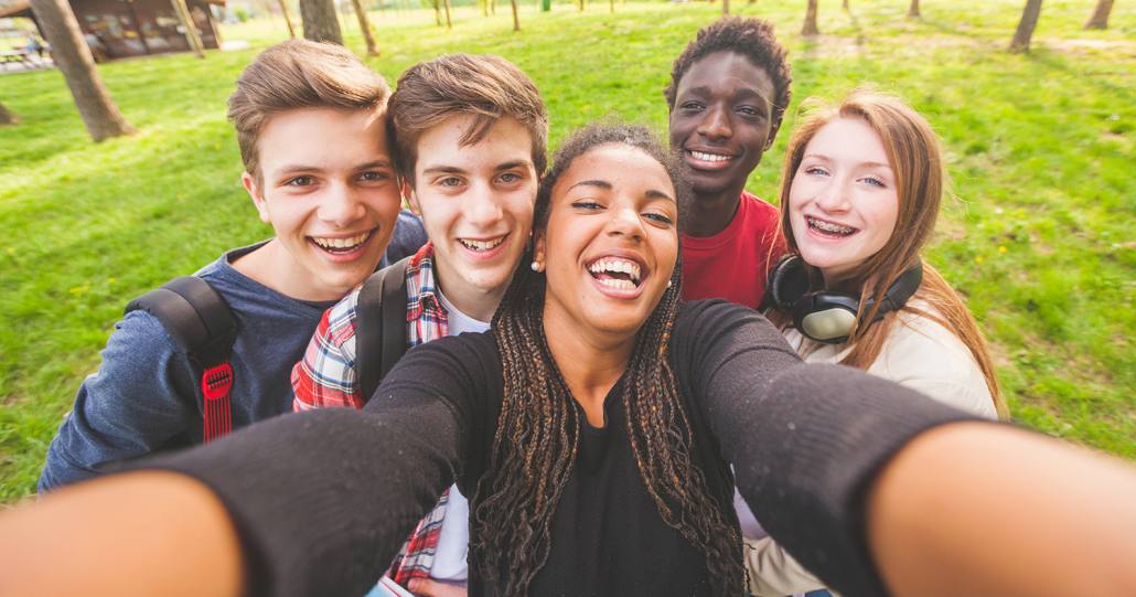 Teenage with braces brings friends to an event at BRO in Asheville, NC