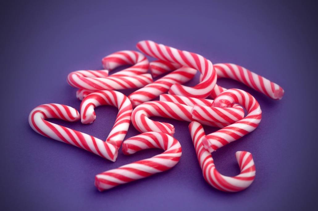 Candy canes collected by girl with braces during the holidays