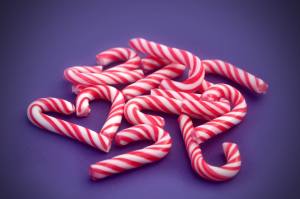 Candy canes collected by girl with braces during the holidays