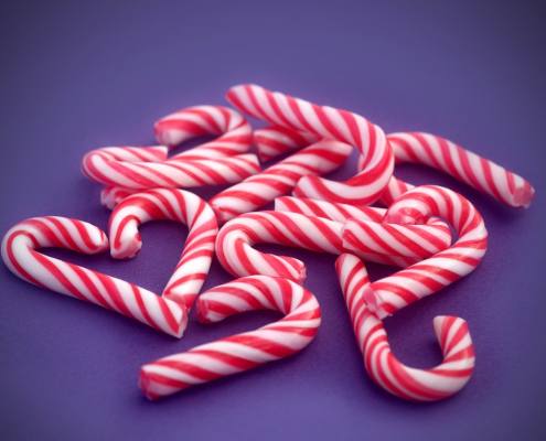 Candy canes collected by girl with braces during the holidays