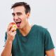 Man with braces snacking on an apple in Western North Carolina