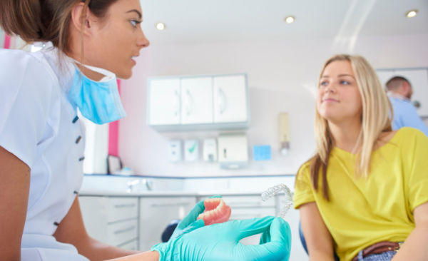 Woman learning about Impressions at-home invisible aligners during orthodontic consultation in Asheville