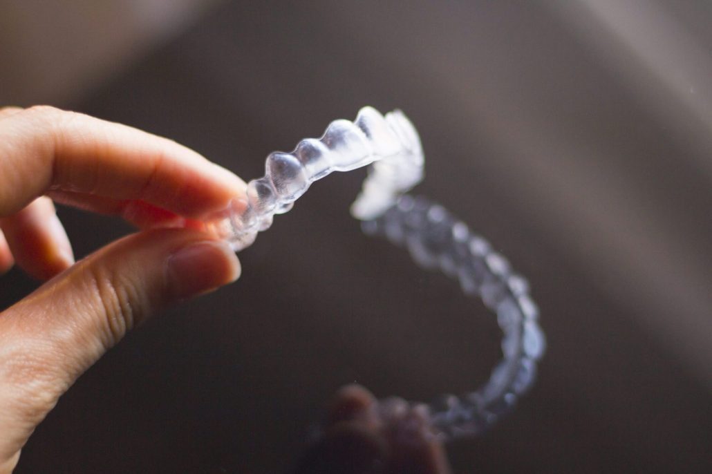 Woman about to use Invisalign cleaning crystals on her aligners at home