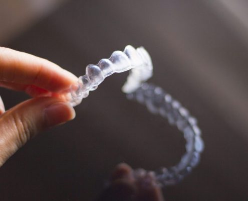 Woman about to use Invisalign cleaning crystals on her aligners at home