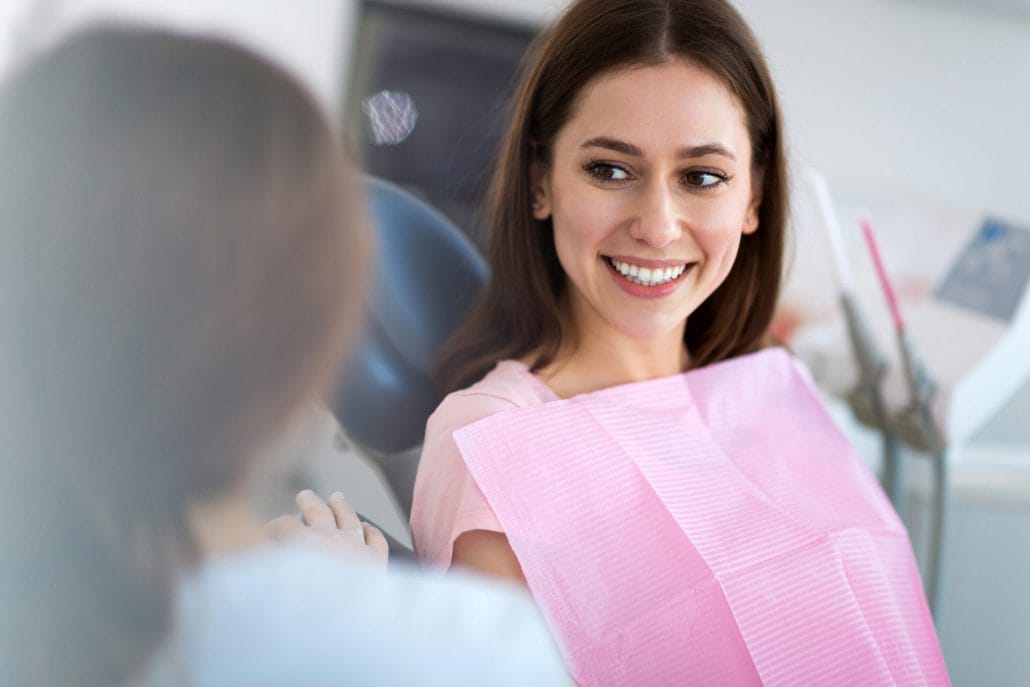 Wisdom Teeth Removal 5 Smiling patient talking with the oral surgery team during a wisdom teeth consultation