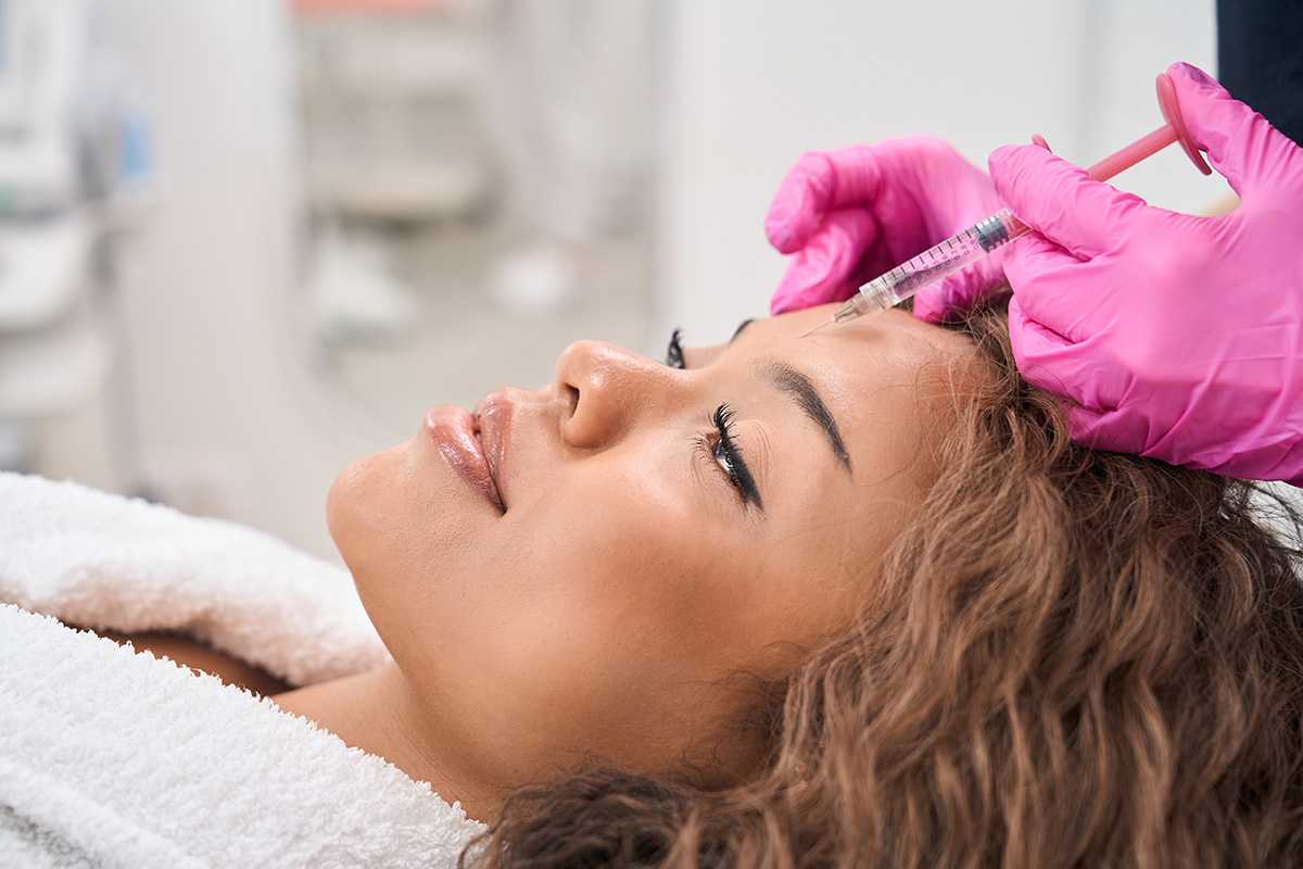 save on botox asheville - Modern woman receives botulinum toxin injections in a cosmetology clinic, patient is provided with maximum comfort and attention