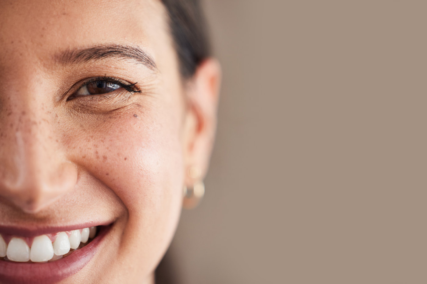 Close-up of a woman with a bright, confident smile